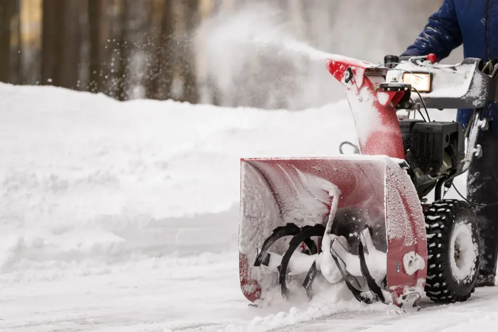 Snow plow clearing commercial parking lot