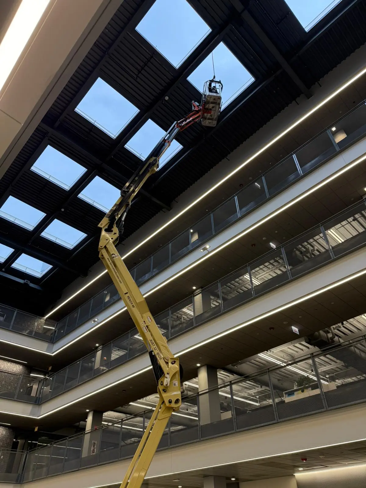 Worker suspended on ropes cleaning a tall building