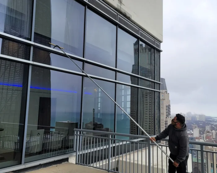 Glass panels cleaned by technician inside a lobby