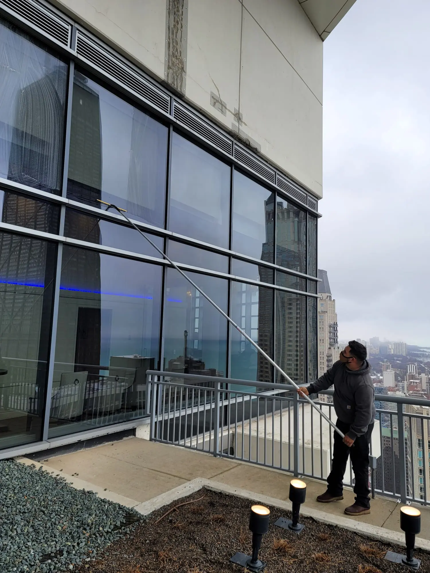 Glass panels cleaned by technician inside a lobby